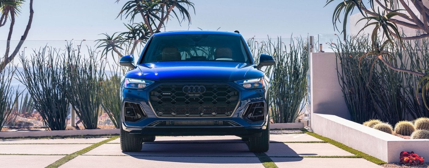A blue 2025 Audi Q5 for sale parked on a driveway.